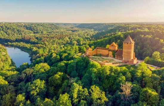 Aerial view of Turaida Castle surrounded by autumn forest near Sigulda